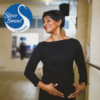 A woman in a Silver Swans class holding a ballet pose