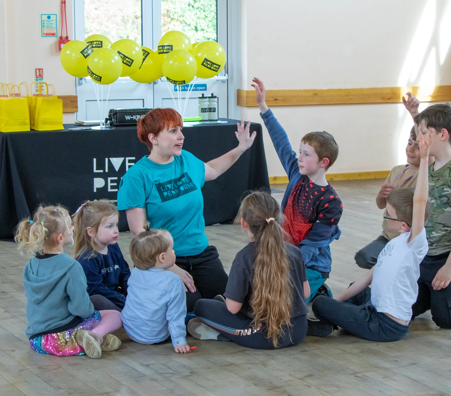 A group of children dancing to music at a party hosted by Live Love Perform